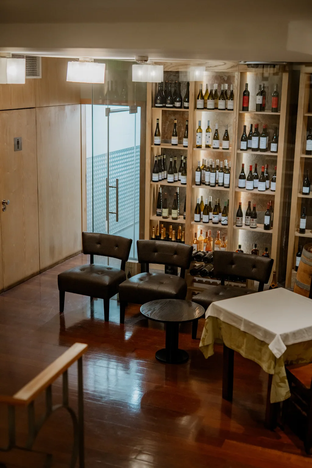 Anteroom with low chairs and the wine cellar beyond